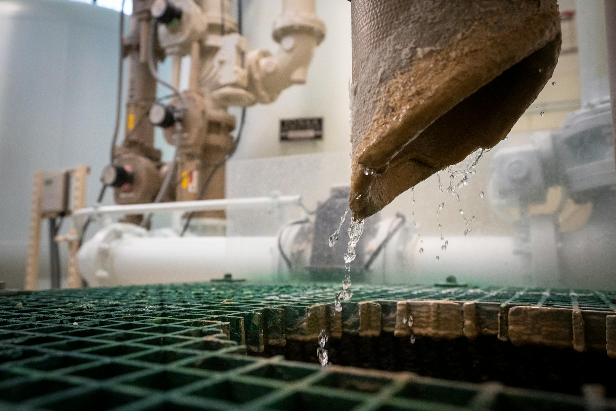 Water drips out of a pipe at the Hastings Water Treatment Plant in Hastings, Minn.