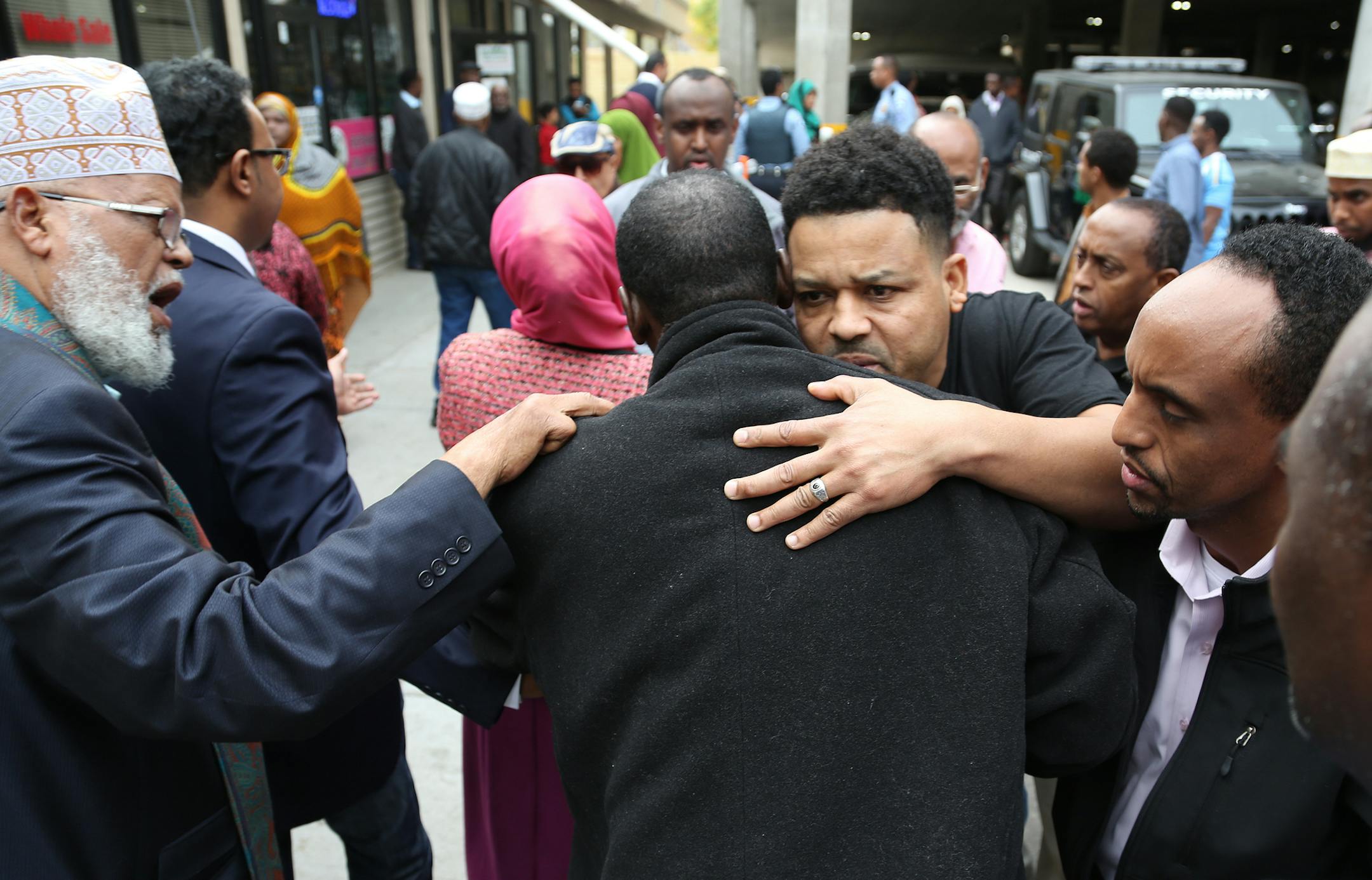 Abdirahman Mohamed, of Nashville, son of shooting victim Abdi Haji Mohamed Liiban, received hugs and support from community members after making the 14-hour drive to Minneapolis.