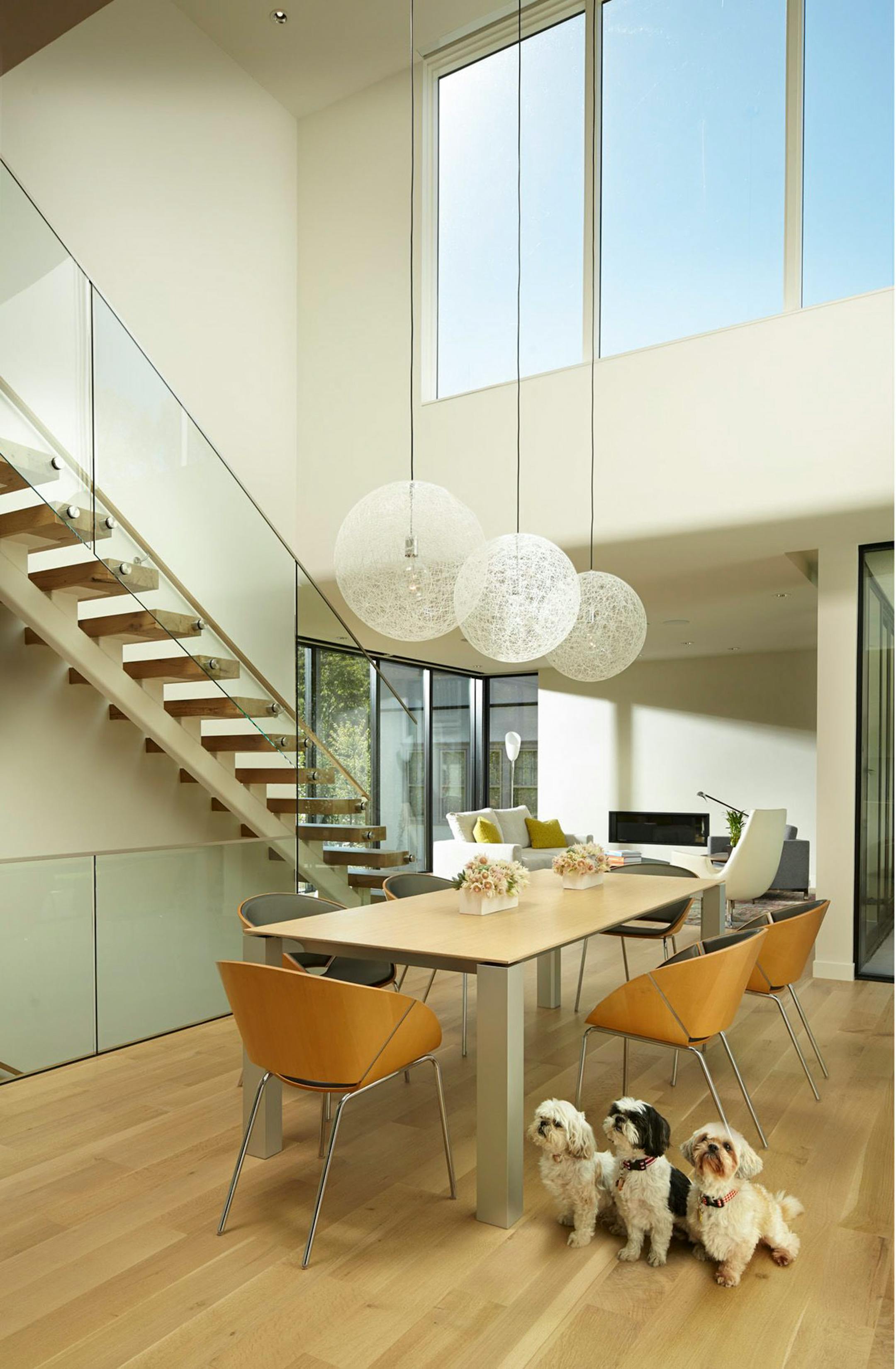 A bank of high windows draws light into a dramatic two-story space in the center of the home.