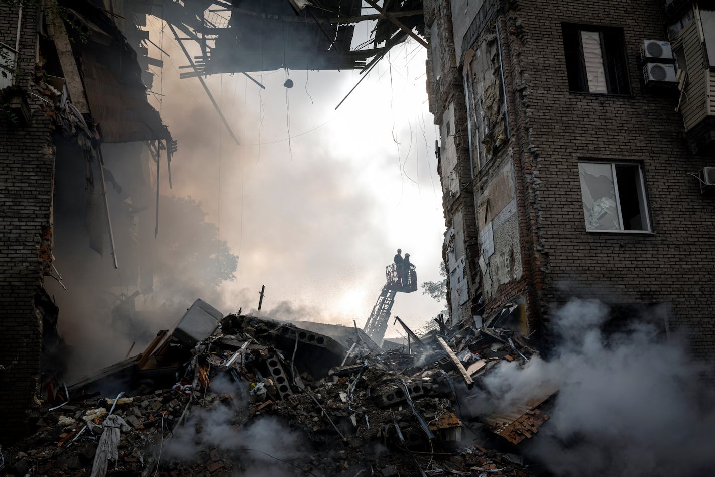 FILE Ñ Emergency workers at the scene of a Russian missile strike on Zaporizhzhia, Ukraine, on Monday, Oct. 10, 2022. A New York Times investigation based on interviews, intercepts, documents and secret battle plans shows how a Òwalk in the parkÓ became a catastrophe for Russia. (Nicole Tung/The New York Times)