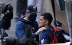 Minnesota Twins manager Rocco Baldelli speaks to starting pitcher Jose Berrios, right, in the dugout during the fifth inning of Game 2 in the American