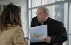 Archbishop Bernard Hebda spoke to a woman after a U.S. Bankruptcy Court in September 2018 approved a settlement that includes $210 million for more th