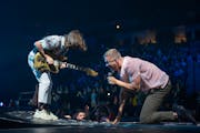 Lead singer Dan Reynolds with Imagine Dragons guitarist Wayne Sermon performing early in the band's set Sunday night, February 27, 2022 at Target Cent