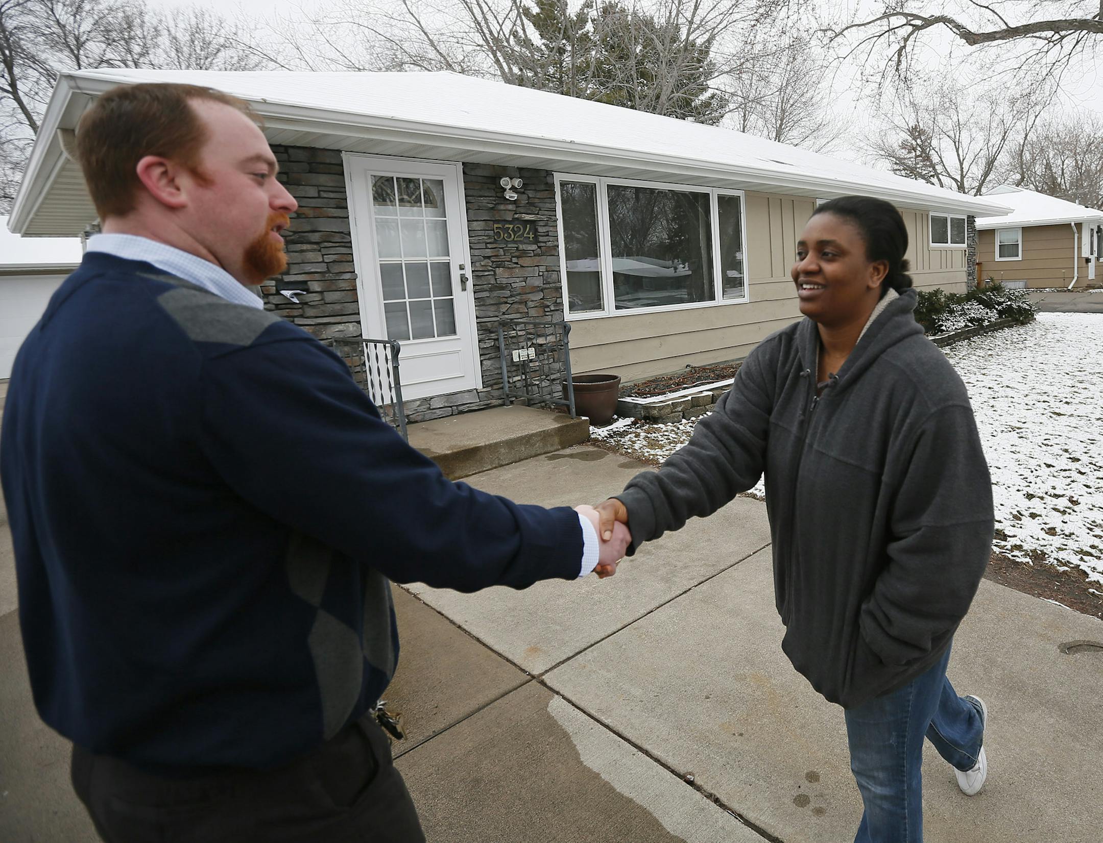 Edwina Karmo right shook hands with her realtor Eric Clark as she and her husband Robertson Karmo walked through their new home Wednesday April, 10 2013 in Brooklyn Center, MN. ] JERRY HOLT ‚Ä¢ jerry.holt@startribune.com