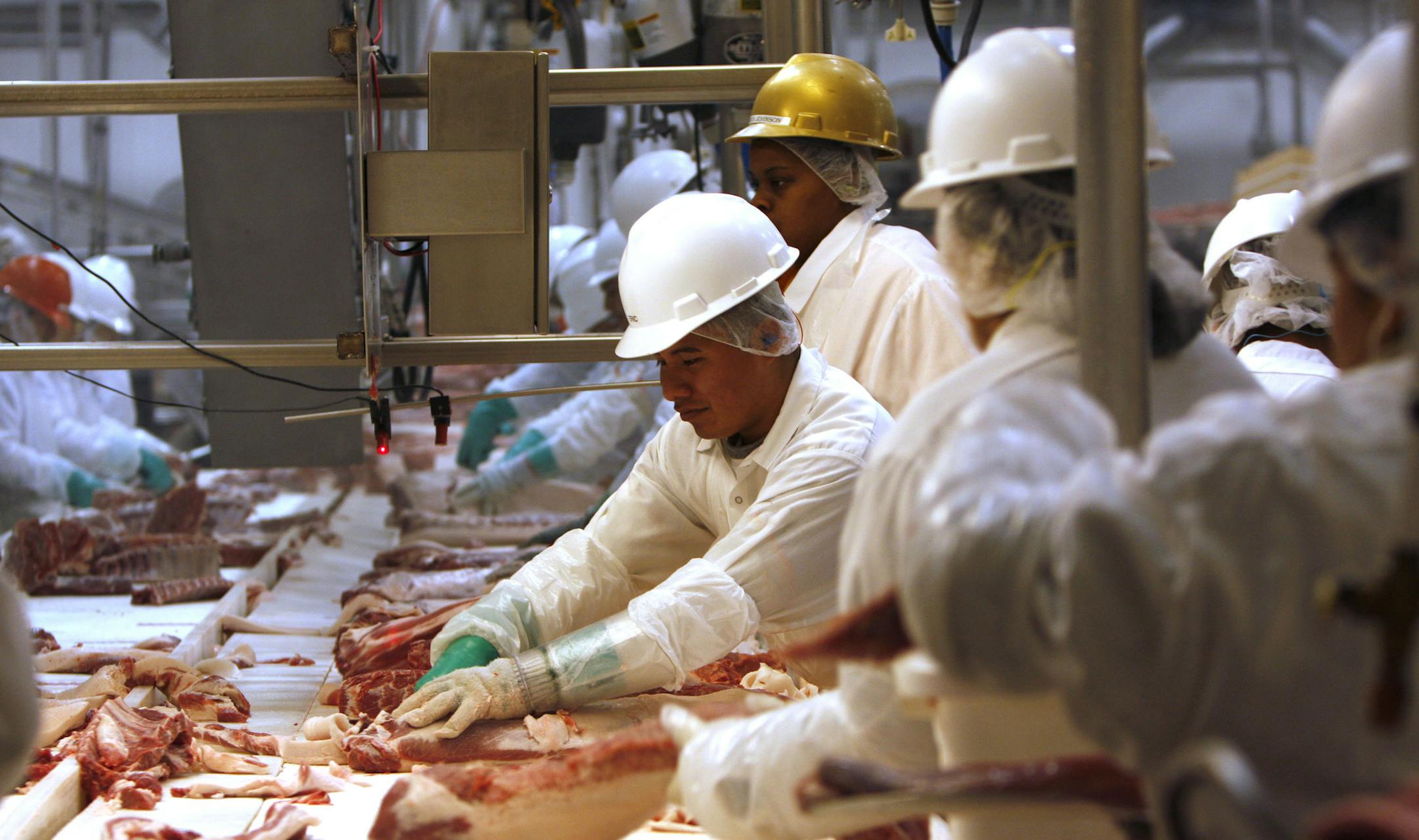 Employees at Meadowbrook Farms Pork process pork for packaging in Rantoul, Ill. (Jose More/Chicago Tribune/TNS)