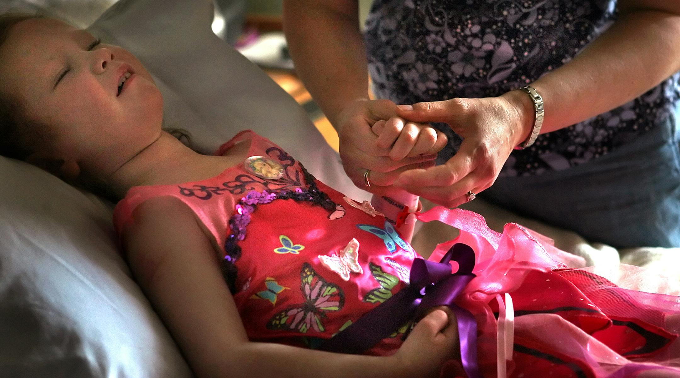 Christina Prindle comforted her five-year-old daughter, Annika, at Gillette Children's Hospital in St. Paul. Annika was severely injured when a tornado struck the Prindle's home in Hugo. Nathanial Prindle, 2, was killed in the tornado.