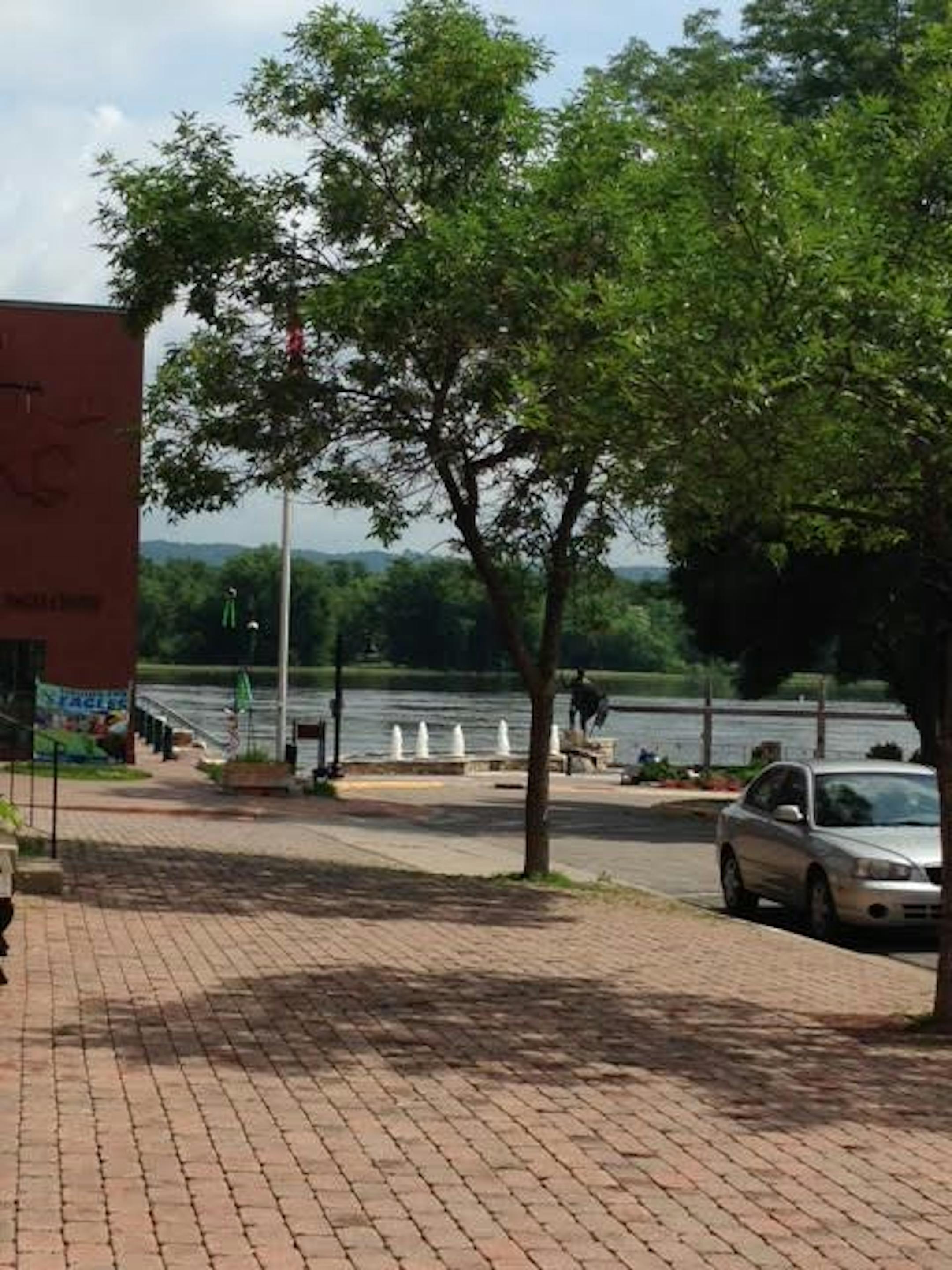 The swollen Mississippi rolls by, but not over, downtown Wabasha.