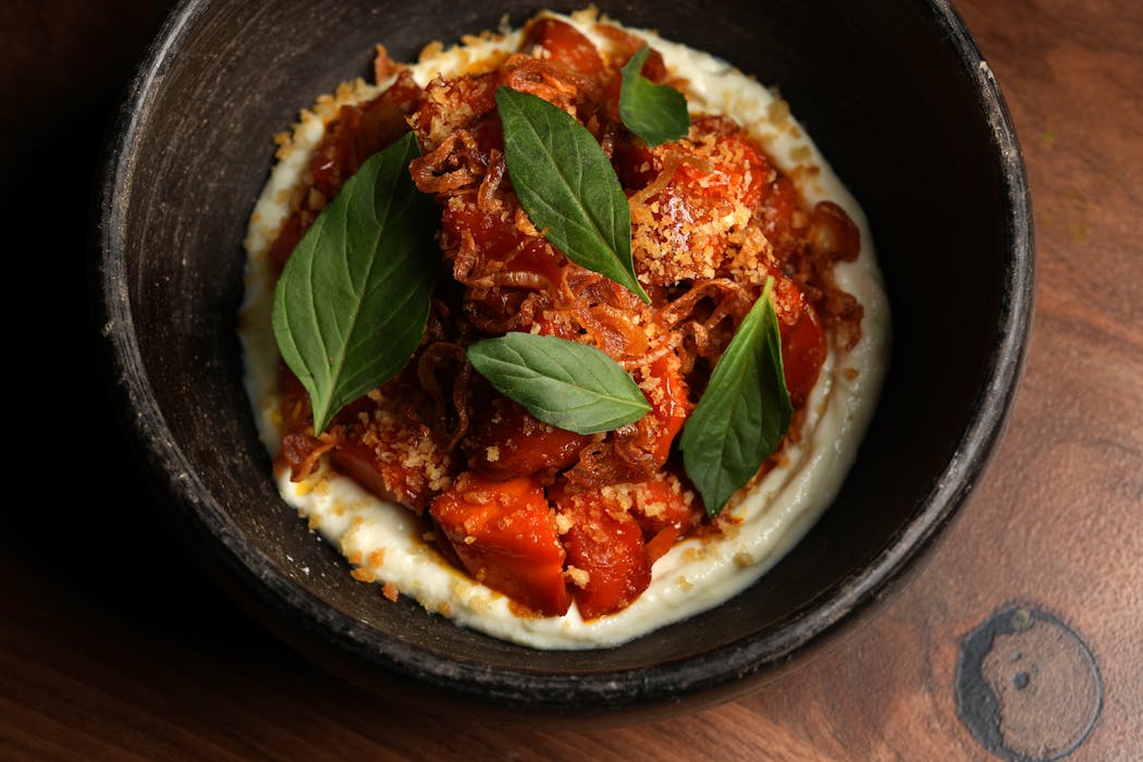 The glazed carrots at Porzana are served on a bed of ricotta and topped with crispy shallots and Thai basil. 