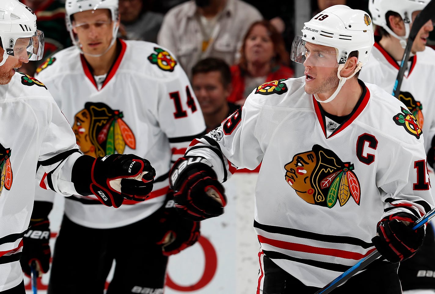 Jonathan Toews (19) celebrated with teammates after scoring a goal in the second period.