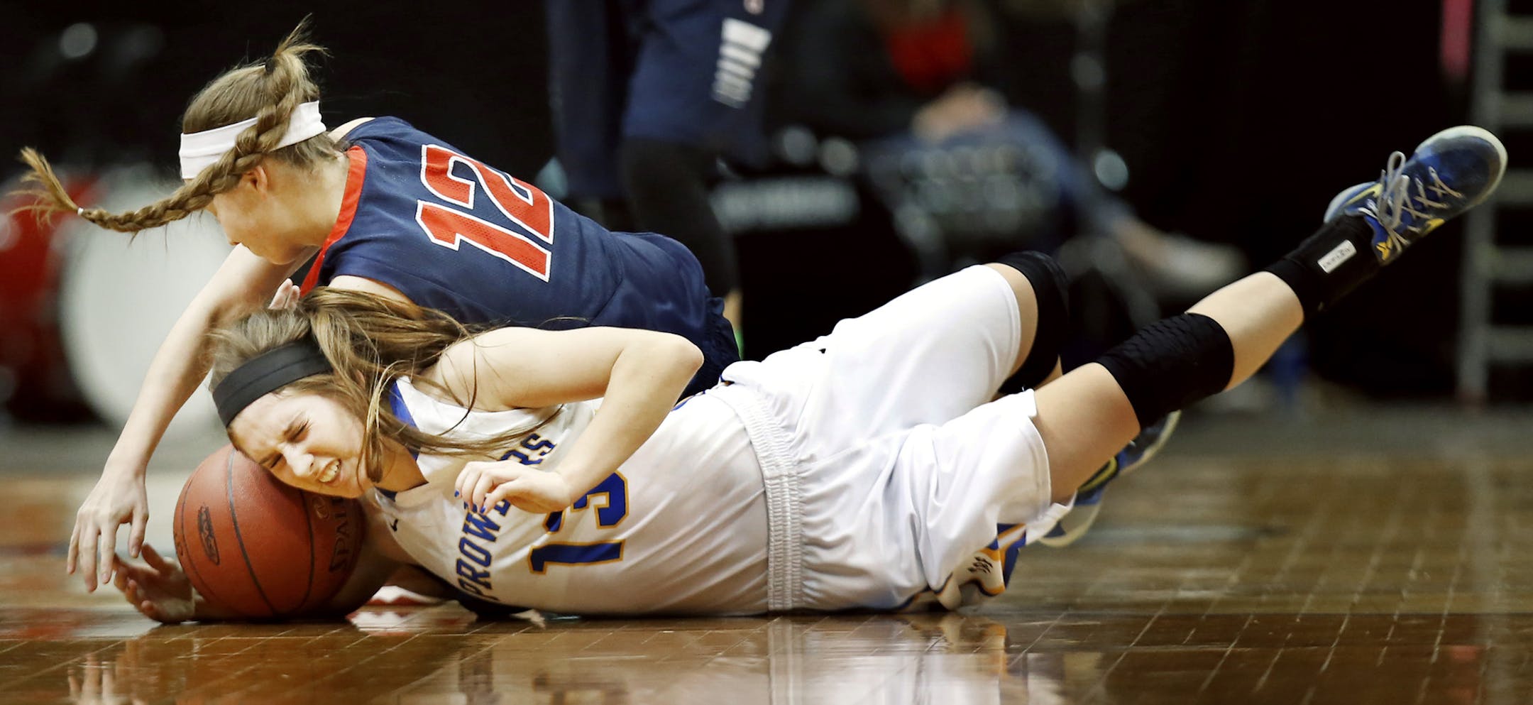 Prowlers Kylea Praska and Spartans Lily McKown dove a loose ball in the first half. Orono High School Spartans played Thief River Falls Prowlers Class 3A quarterfinal action March 17, 2015 in Minneapolis, Minnesota. ] Jerry Holt/ Jerry.Holt@Startribune.com