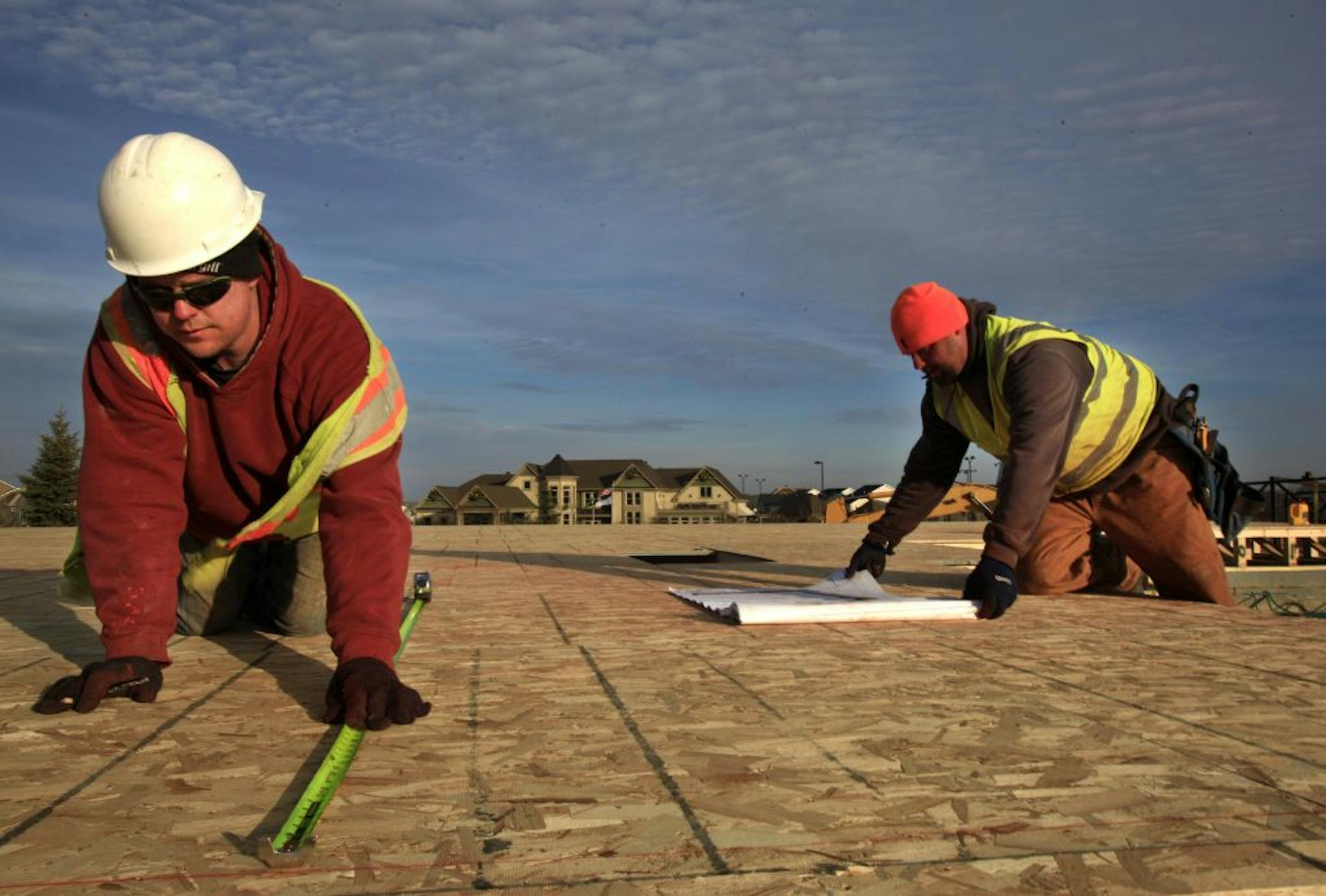 Dan Henderson, left, and Frank Bassett worked on a new home Wednesday at Four Seasons at Rush Creek in Maple Grove.
