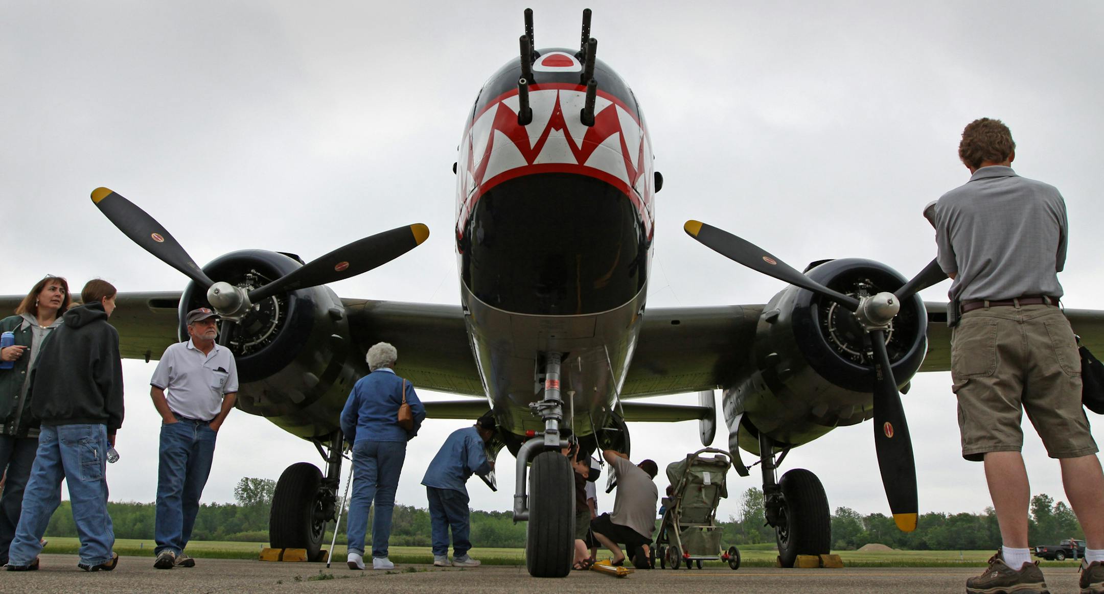 BRUCE BISPING • bbisping@startribune.com Blaine, MN., Saturday, 5/22/2010] (left to right) Aviation fans walked by Betty's Dream, a B-25 Mitchell WW2 bomber during the EAA Chapter #237 Annual Blaine Aviation Weekend at Anoka County Airport. The show features World War Two warbirds, pancake breakfast, a 1940's hanger dance, vintage aircraft displays at the Golden Wings Museum and helicopter rides.