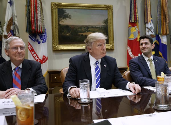 President Donald Trump, flanked by Senate Majority Leader Mitch McConnell of Ky. and House Speaker Paul Ryan of Wis., hosts a meeting with House and S