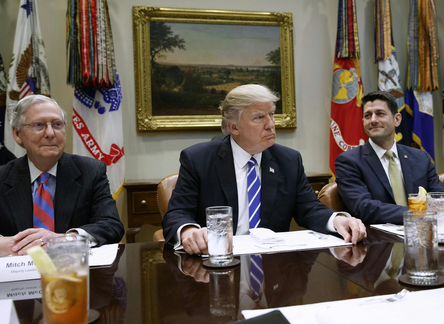 President Donald Trump, flanked by Senate Majority Leader Mitch McConnell of Ky. and House Speaker Paul Ryan of Wis., hosts a meeting with House and Senate leadership, Wednesday, March 1, 2017, in the Roosevelt Room of the White House in Washington. (AP Photo/Evan Vucci)