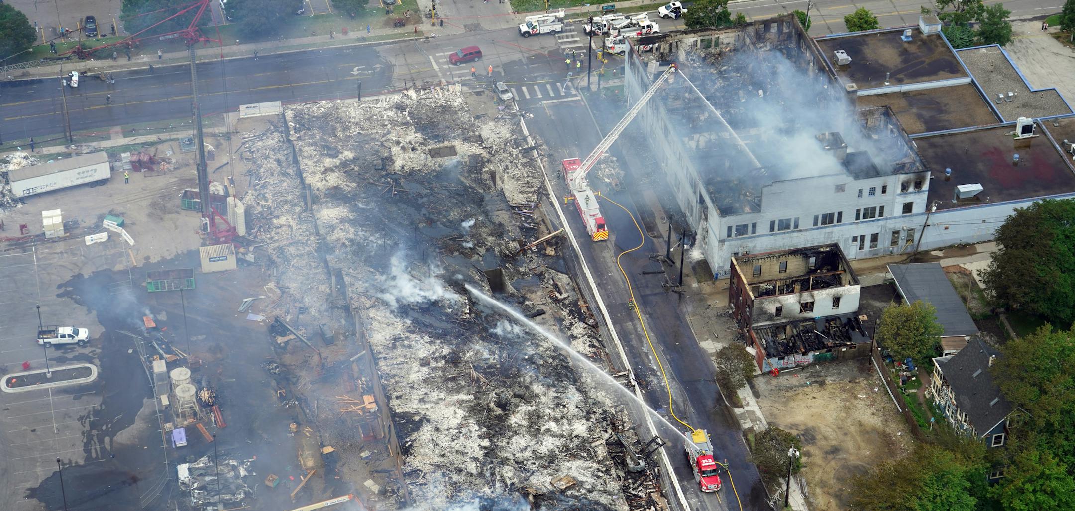 Minneapolis residents awoke Thursday to assess the damage after rioters ignited fires and looted stores all over the city, as peaceful protests turned increasingly violent in the aftermath the death of George Floyd during an arrest. Here, the 190-unit apartment building under construction, tentatively known as Midtown Corner (left), was burned to the ground at 26th Ave and 29th Street. brian.peterson@startribune.com Minneapolis, MN Thursday, May 28, 2020