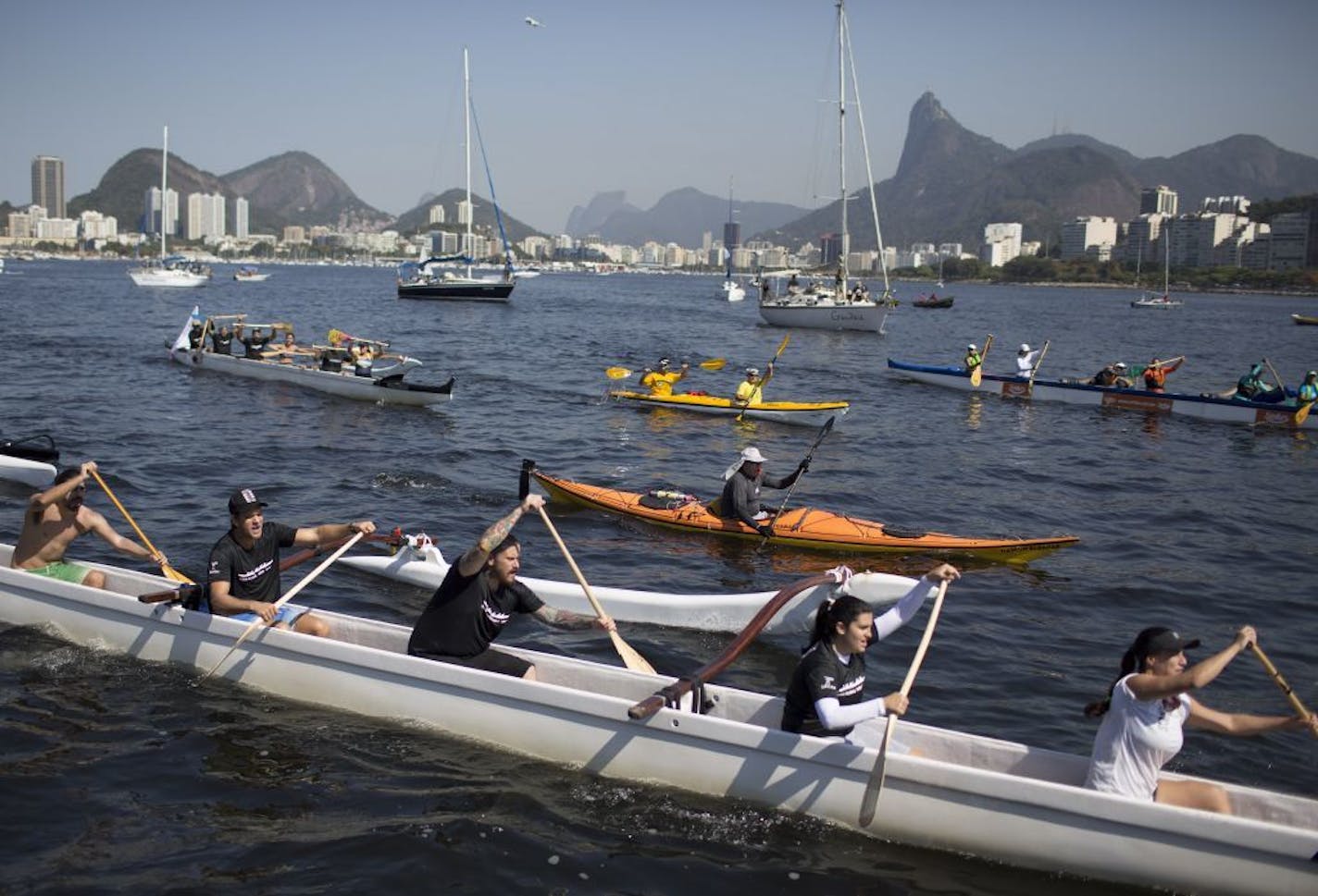 People row their boats as part of a protest against the polluted waters of Guanabara bay in Rio de Janeiro, Brazil, Saturday, Aug. 8, 2015.