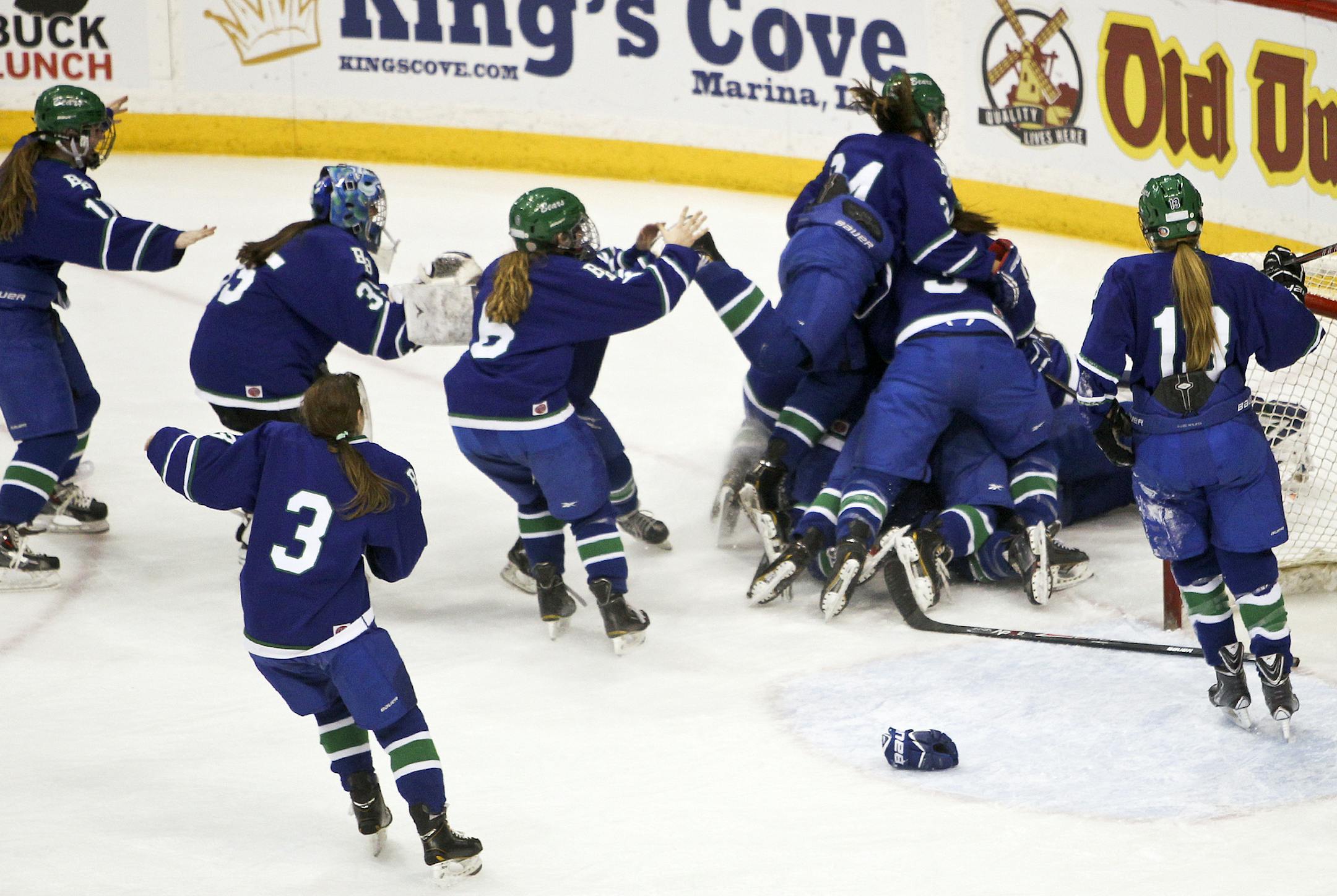Blake School players pile on their goalie Anna Kruesel, an eighth grader, while celebrating their 3-2 come-from-behind victory over East Grand Forks High Saturday, March 22, 2014, at the Xcel Energy Center In St. Paul, MN.](DAVID JOLES/STARTRIBUNE) djoles@startribune.com Girls' hockey, Class 1A championship game Saturday, March 22, 2014, at the Xcel Energy Center In St. Paul, MN.**Anna Kruesel,cq
