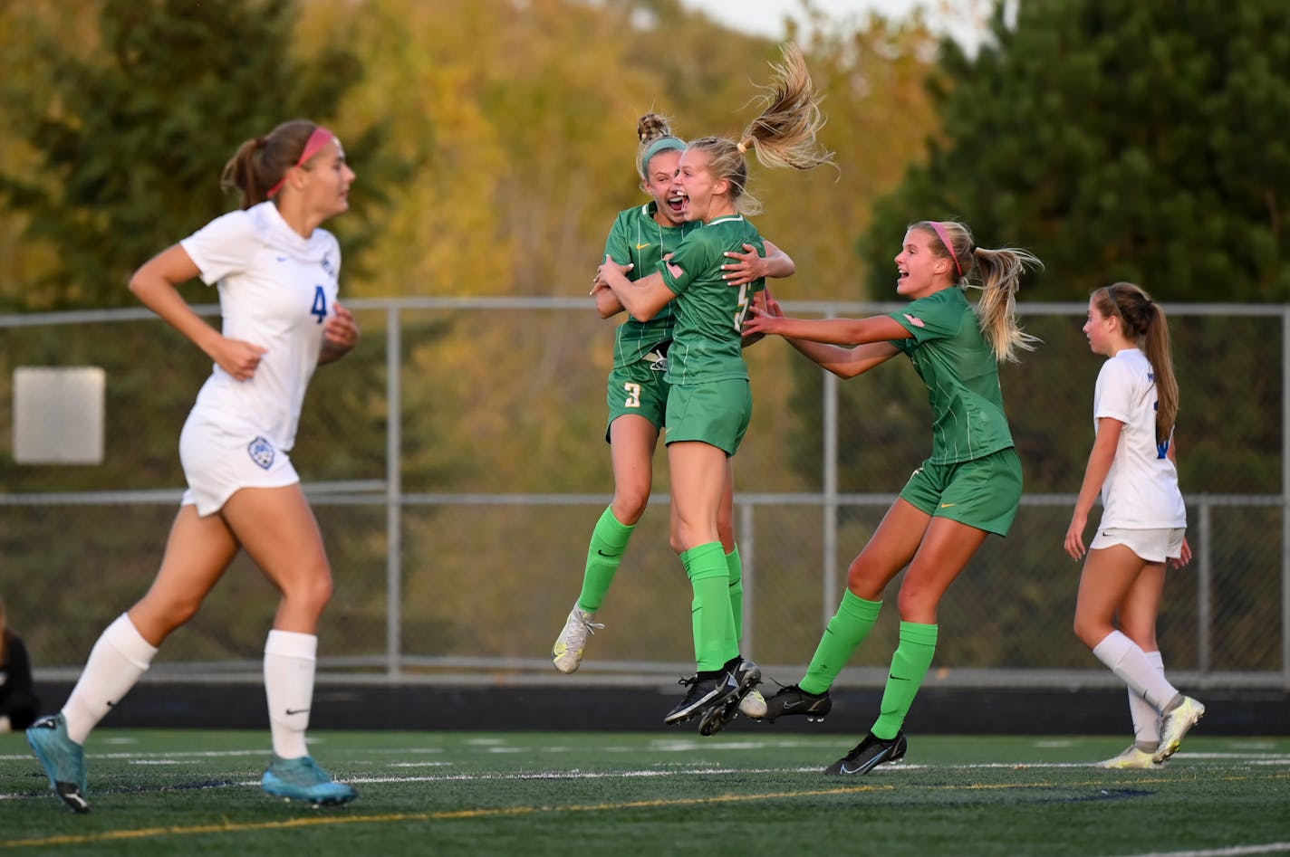 Edina midfielder Izzy Engle (3) celebrates with forward Maddie Dahlien (5) after Dahlien scored a goal against Minnetonka during the first half of the girls Class 3A, Section 2 Championship soccer game at Prior Lake High School Tuesday Oct. 19, 2021, in Savage, Minn.