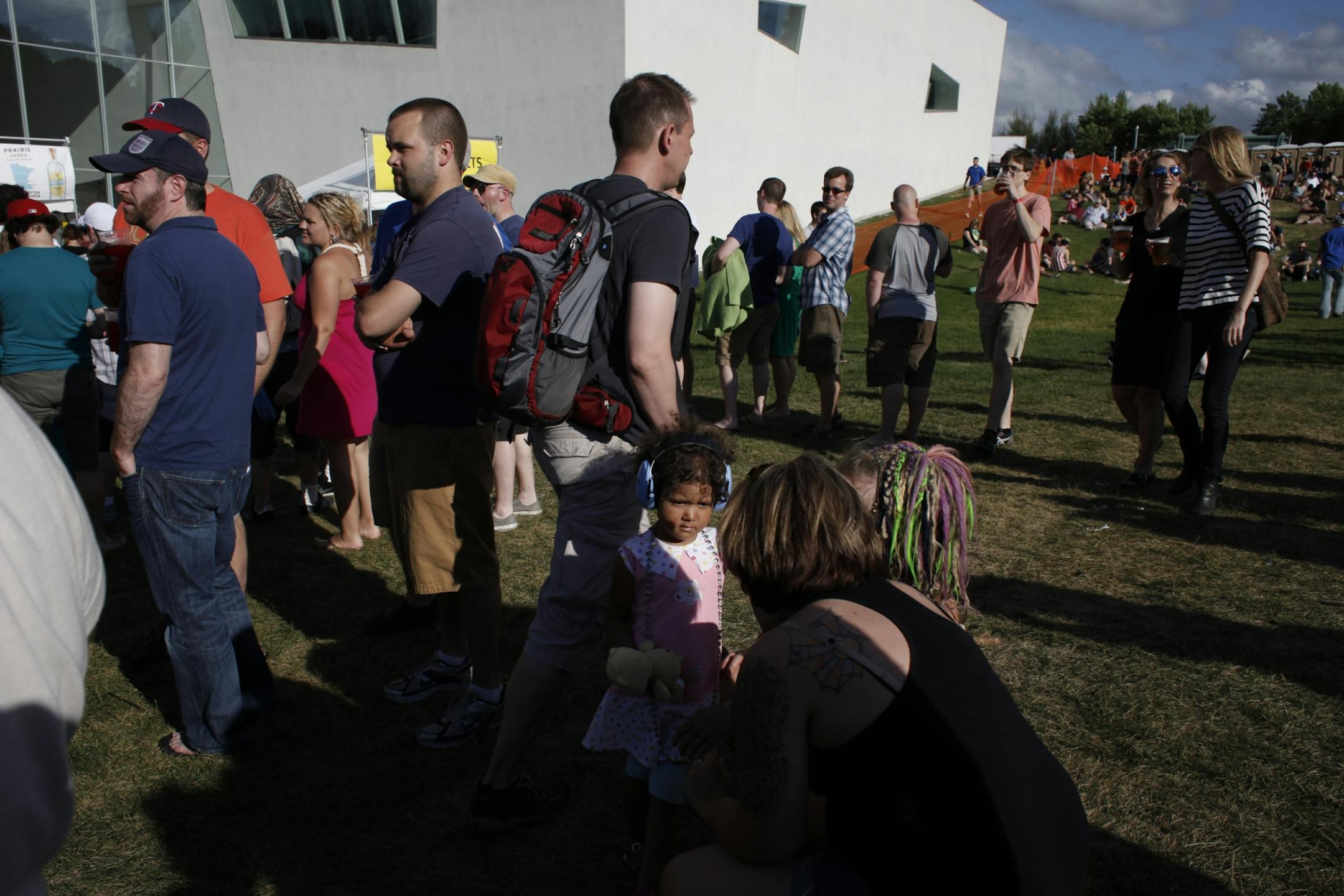 Ava Vice, 3, wears earplugs as she accompanies her mother Byrnn Vice and Carly Stone to the 2012 Rock the Garden concert in Minneapolis, Minn. on Saturday, June 16, 2012.