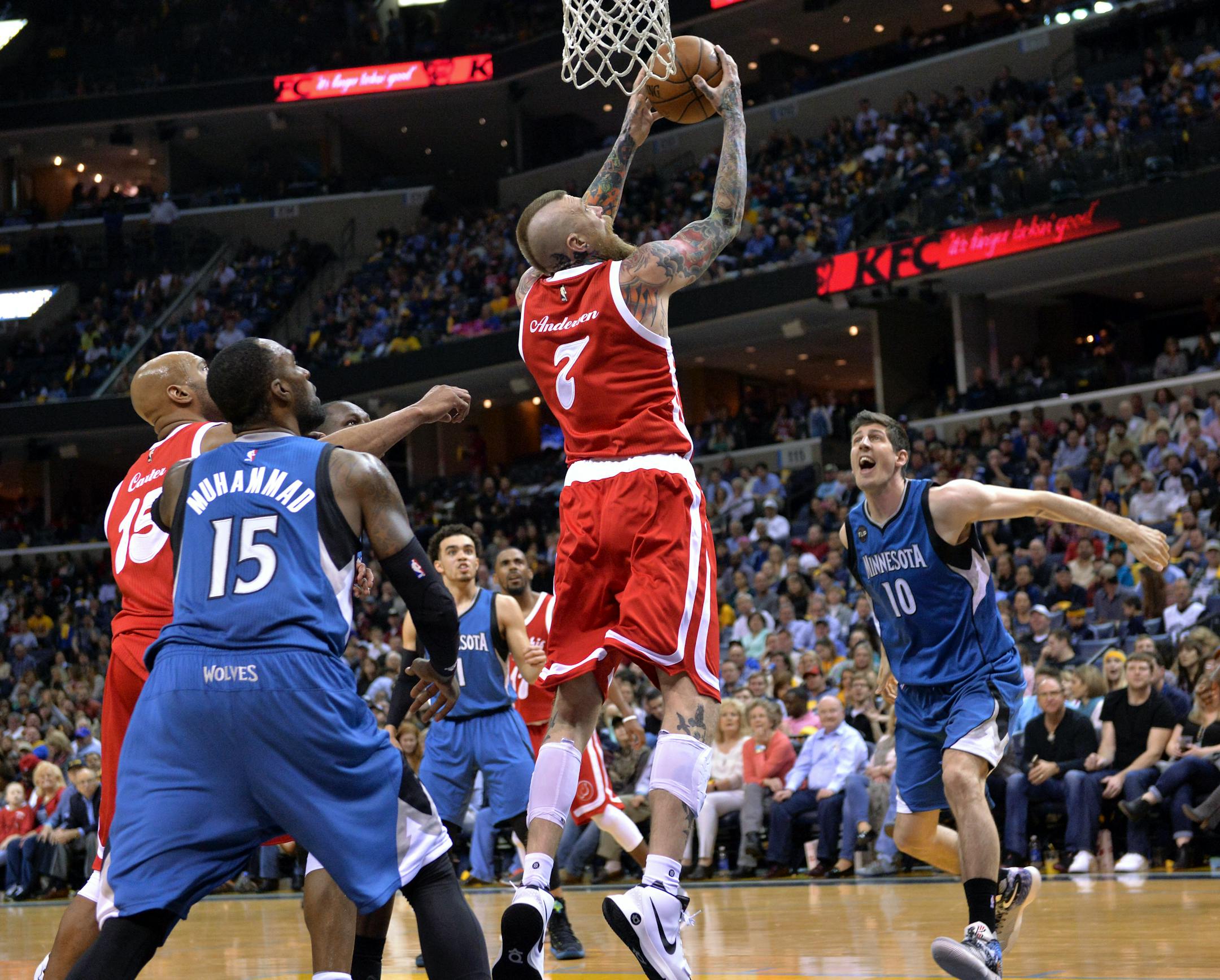 Memphis Grizzlies center Chris Andersen (7) shoots between Minnesota Timberwolves forwards Shabazz Muhammad (15) and forward Damjan Rudez (10) during the second half of an NBA basketball game Friday, Feb. 19, 2016, in Memphis, Tenn. (AP Photo/Brandon Dill)