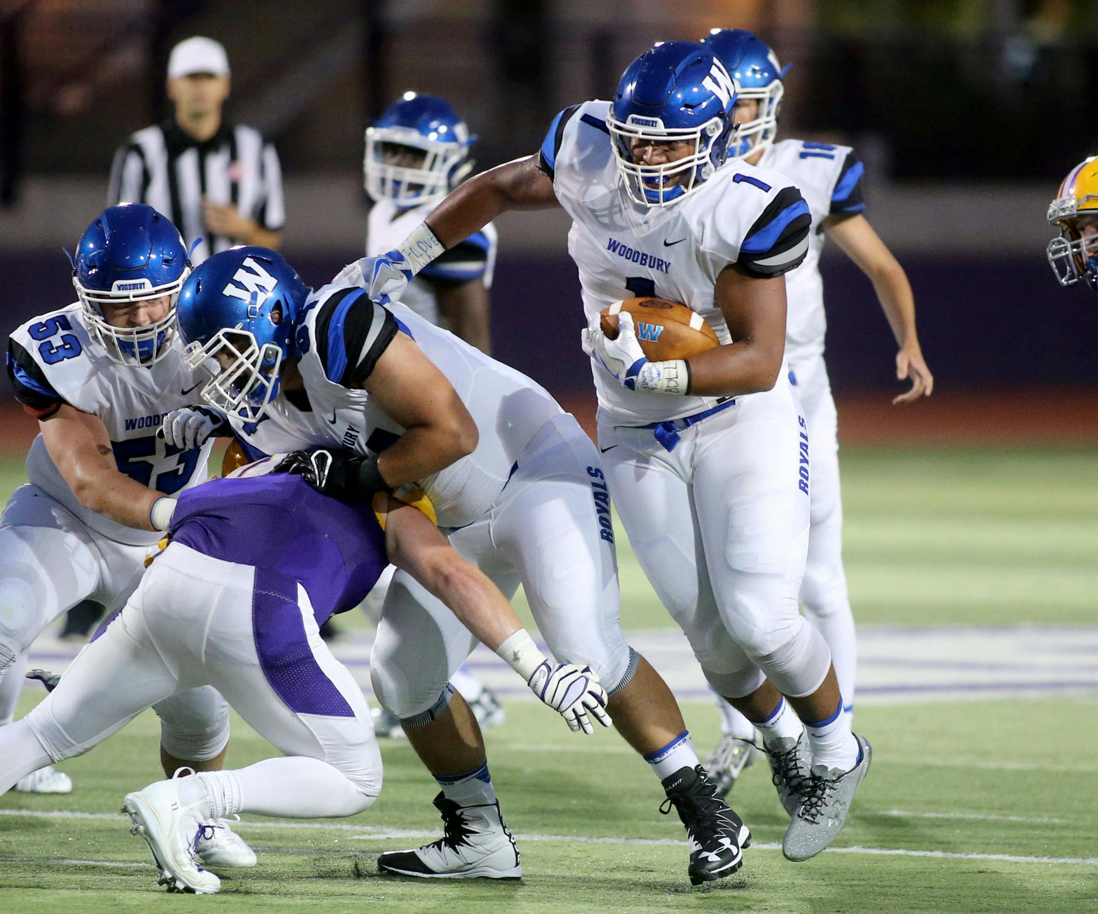 Woodbury High running back Jalen Morrison (1) finds a hole in the Cretin-Derham Hall defense during the second quarter Friday, Sept. 9, 2016, at St. Thomas University in St. Paul, MN.(DAVID JOLES/STARTRIBUNE)djoles@startribune.com Woodbury vs. Cretin-Derham Hall Friday, Sept. 9, 2016, at St. Thomas University in St. Paul, MN.