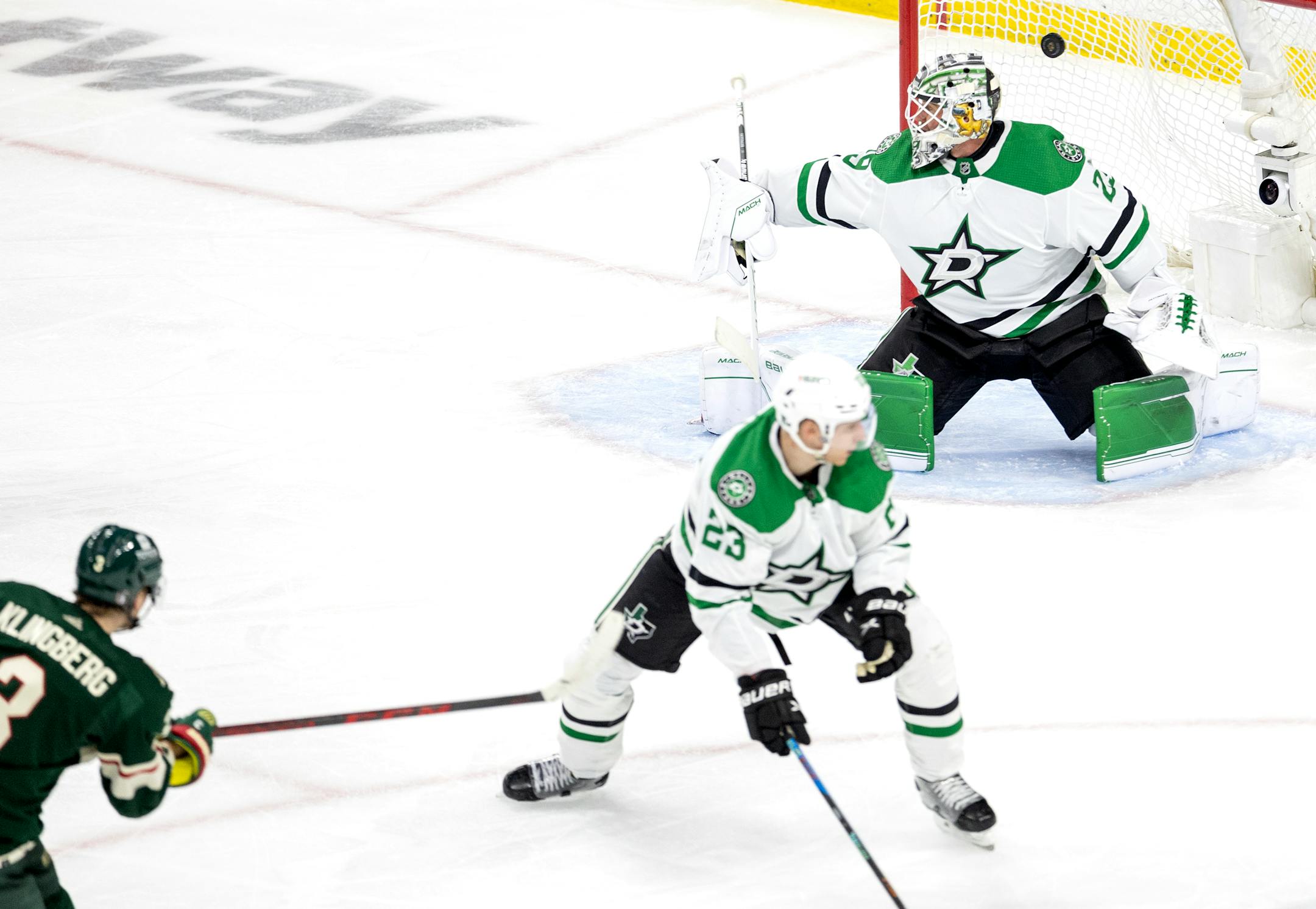 John Klingberg (3) of the Minnesota Wild gets the puck past Dallas Stars goalie Jake Oettinger for a goal in the third period.