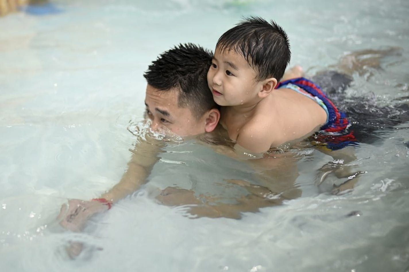 Nevin,1, of Brooklyn Park, took a ride on the back of his father, Richard Vang, while playing in the expansion of the indoor water park at the Shoreview Community Center Friday afternoon.