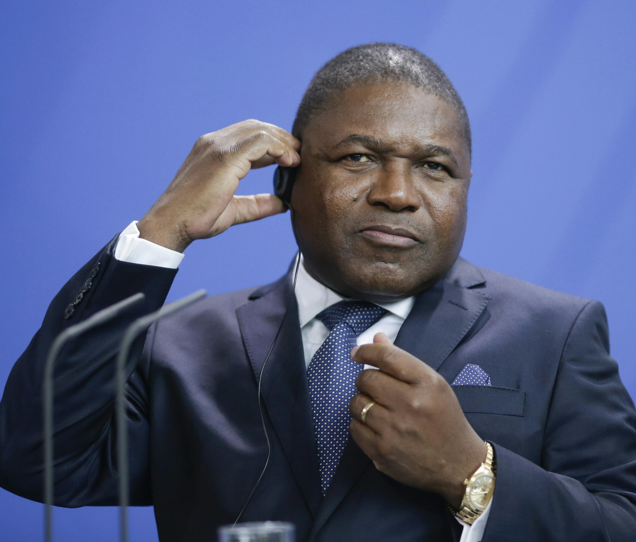 The President of Mozambique Filipe Jacinto Nyusi adjusts his earphones during a news conference with German Chancellor Angela Merkel after a meeting at the chancellery in Berlin, Tuesday, April 19, 2016. (AP Photo/Markus Schreiber) ORG XMIT: MSC121