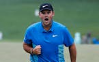 Patrick Reed reacts after making a birdie putt on the ninth hole during the third round at the Masters