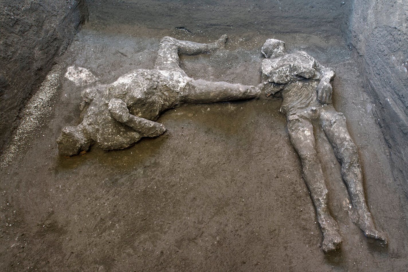 The casts of what are believed to have been a rich man and his male slave fleeing the volcanic eruption of Vesuvius nearly 2,000 years ago are seen in what was an elegant villa on the outskirts of the ancient Roman city of Pompeii.