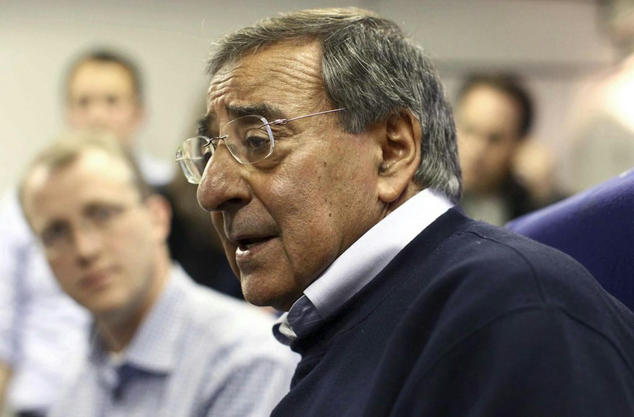 U.S. Secretary of Defense Leon Panetta answers questions aboard an Air Force plane over the Atlantic Ocean Sunday, Oct. 2, 2011.