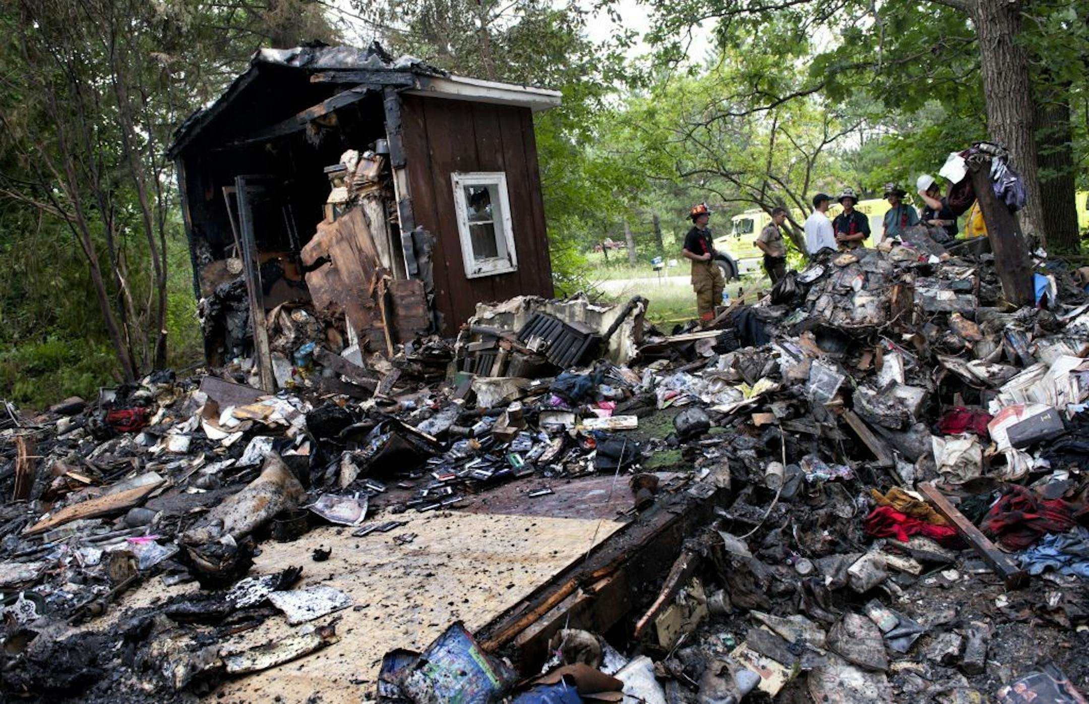 A firefighter took a short break Wednesday after a deadly fire in Linwood Township. The house was filled with clutter.
