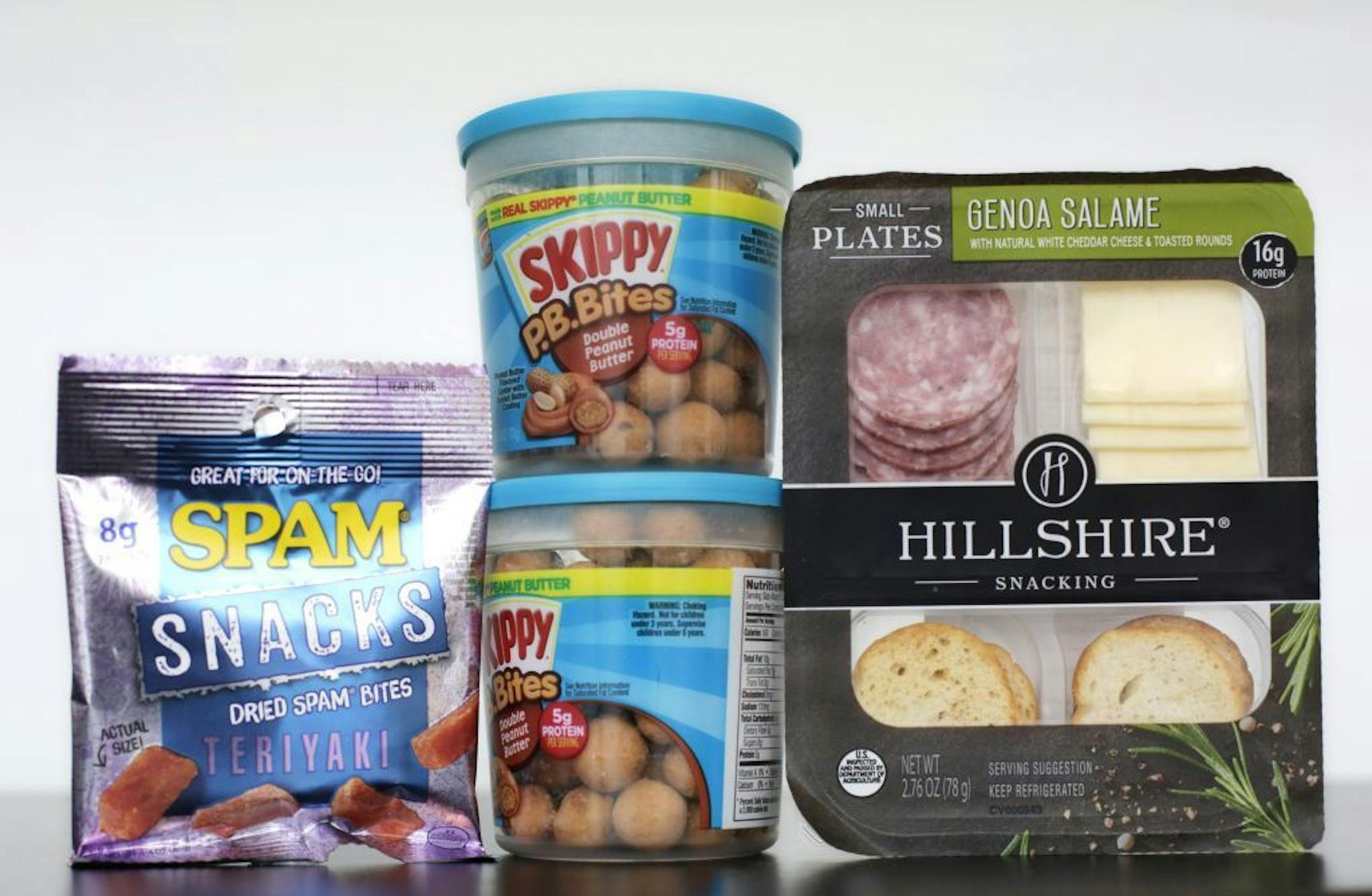 Spam Snacks, left, Skippy P.B. Bites, center, and Hillshire Genoa Salami with cheese and crackers are arranged for a photo, Wednesday, Feb. 24, 2016, in New York. As around-the-clock grazing upends the way people eat, companies are reimagining foods that aren�t normally seen as snacks to elbow in on the trend. That means everything including grilled chicken, cereal, chocolate, peanut butter and Spam are now being marketed as snacks.