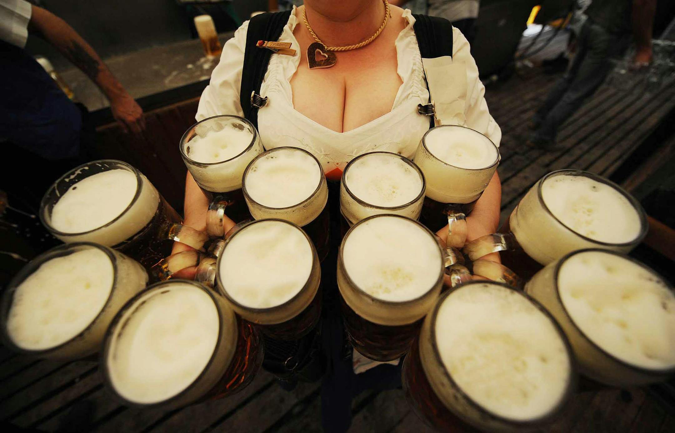 A waitress carries 12 litre-size glasses of beer in a beer tent during the Gillamoos folk festival in the southern German town of Abensberg on September 8, 2008. The world famous Oktoberfest beer festival will take place from September 20 to October 5, 2008 in Munich.