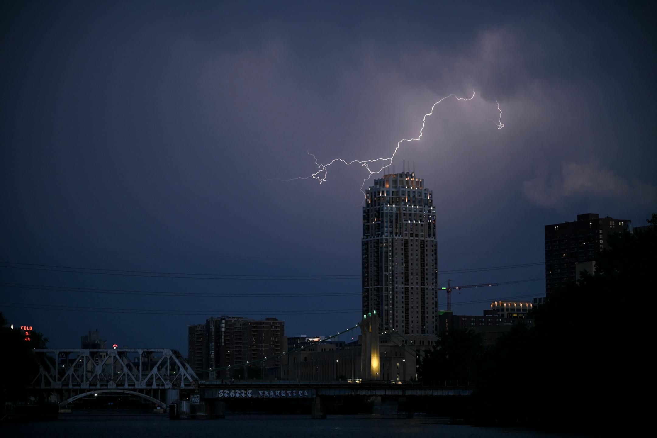 A thunderstorm beyond downtown Minneapolis on Monday night as seen from Boom Island Park.