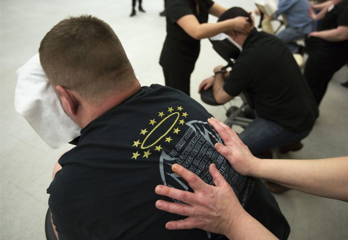 During a busy night at the VFW Post #246 in Minneapolis, veteran Shane Johnson of Minneapolis gets a deep massage from Massage Therapist Rachel Knieff, a student at Northwestern Health Sciences University.