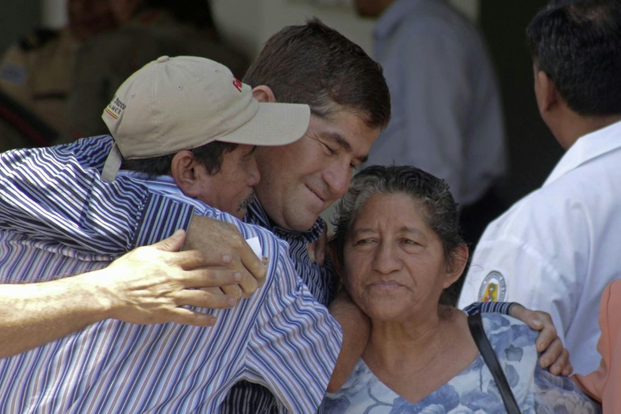 Sea survivor Jose Salvador Alvarenga, center, is embraced by his parents, Ricardo Orellana, left, and Maria Julia Alvarenga outside of the hospital in San Salvador, El Salvador, Tuesday, Feb. 18, 2014.