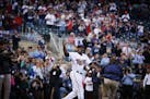 Torii Hunter enters to field to a standing ovation as he is introduced before the Twins home opener against the Kansas City Royals at Target Field in 