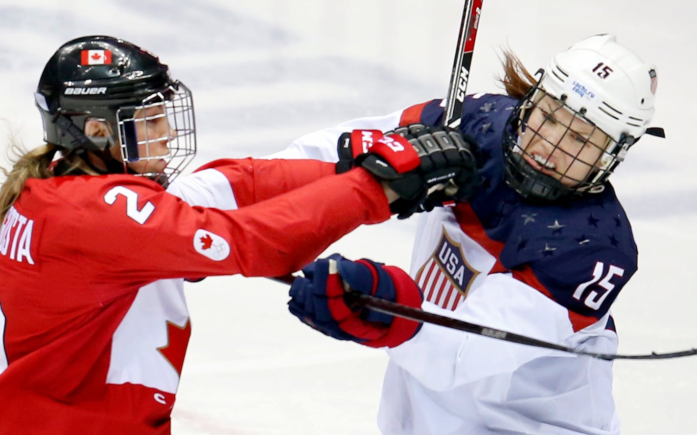 Meghan Agosta (2) and Anne Schleper (15) pushed off of each other in the second period of the gold medal game in Sochi. Team Canada beat Team USA in overtime 3-2.