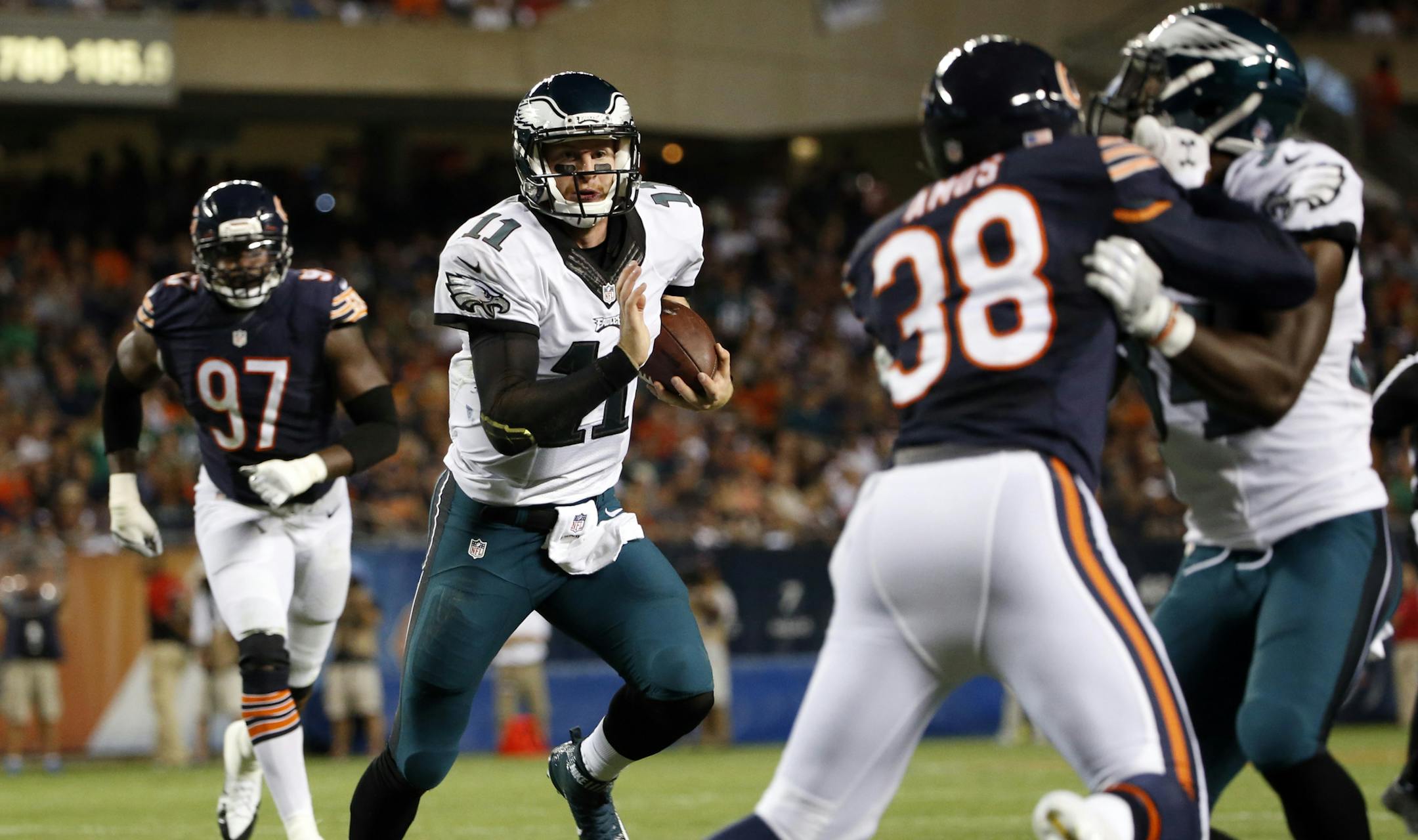 Philadelphia Eagles quarterback Carson Wentz (11) runs the ball against the Chicago Bears defense during the first half of an NFL football game, Monday, Sept. 19, 2016, in Chicago. (AP Photo/Nam Y. Huh)