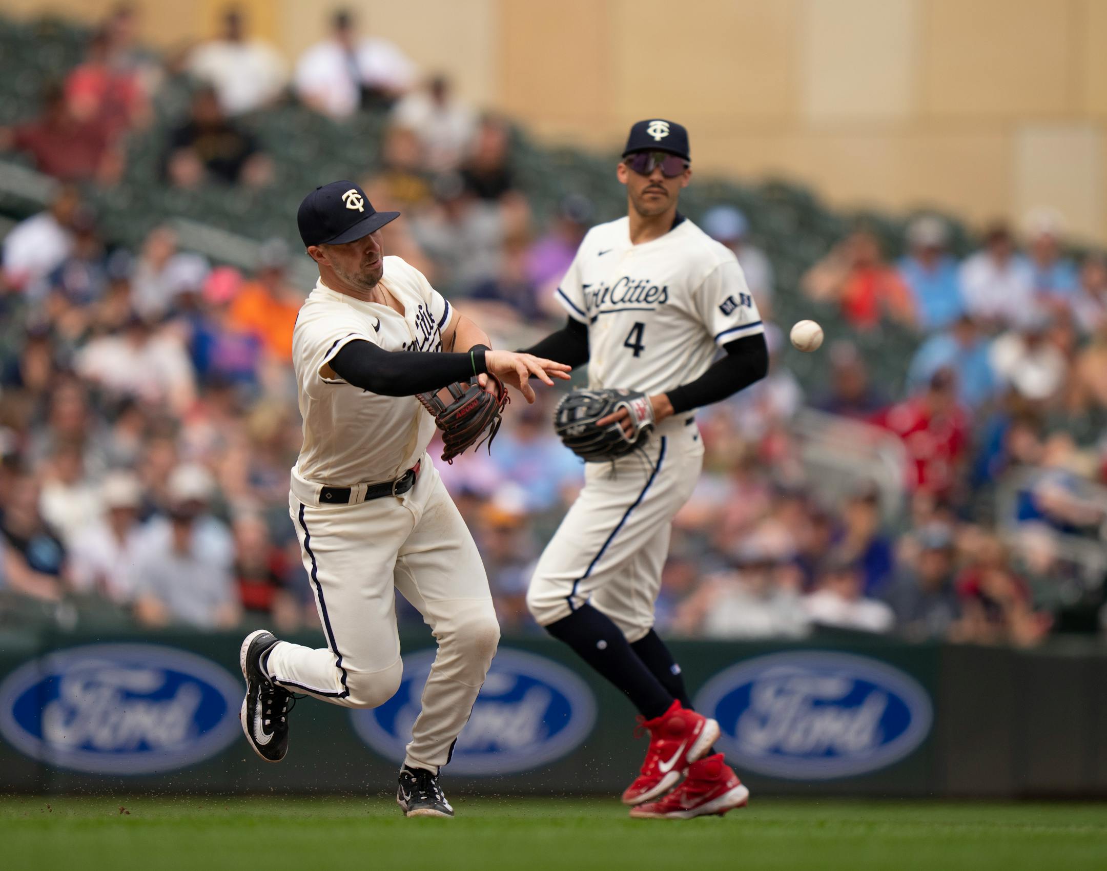 Minnesota Twins third baseman Kyle Farmer (12) threw to second for a force out of Toronto Blue Jays third baseman Matt Chapman (26) in the ninth inning.