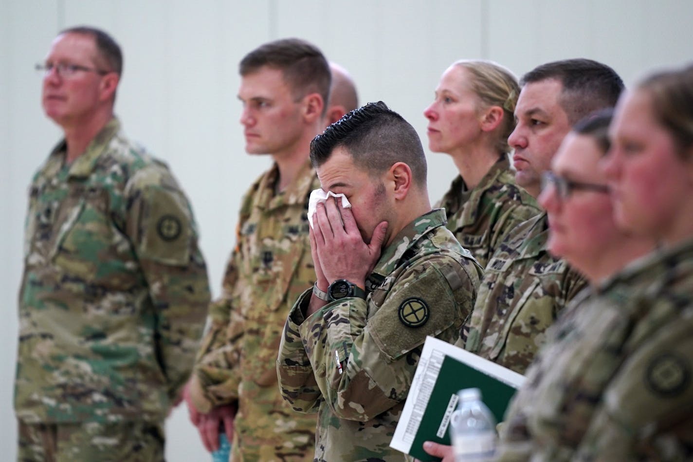 National Guard soldiers somberly listened as Maj. Gen. Jon Jensen spoke during Saturday's news conference about the helicopter crash.