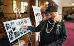 Sharon Nelson, sister of John Nelson and Prince, looked over photo tributes to her late brother John at his funeral service.