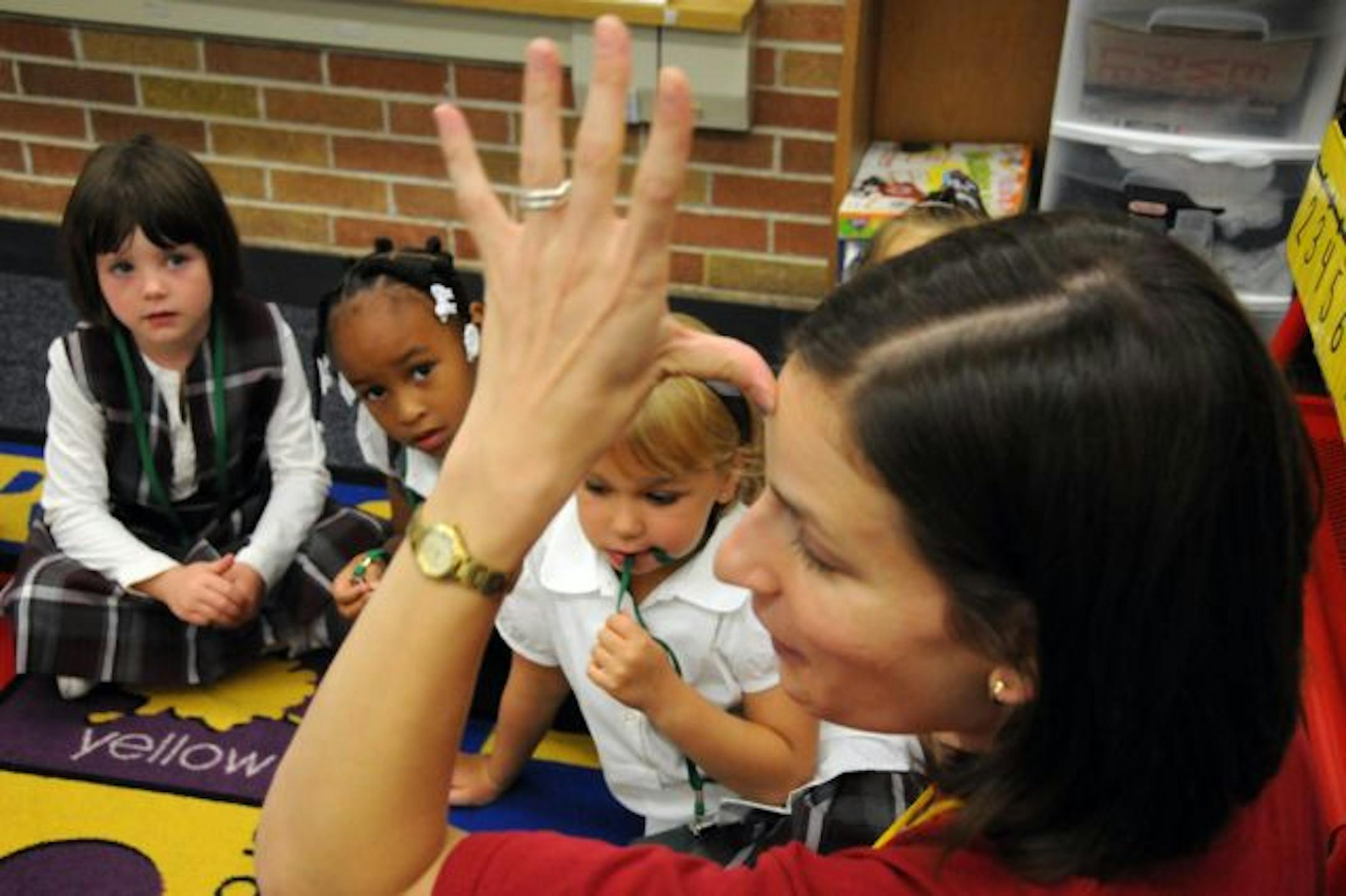 Kindergarten teacher Amy Ponce taught students the sign language for the word "father'' at the Richfield Dual Language School on Tuesday. The school has 350 students in grades K-3.
