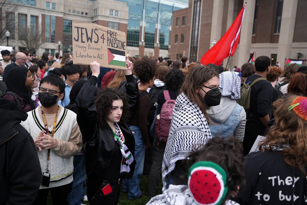 Pro-Palestinian protesters including Mirabai Dornfest, a junior, hold signs during a rally against the war between Israel and Hamas after the University of Minnesota’s campus police cleared the Gaza Solidarity Encampment set up by the UMN Divest coalition.