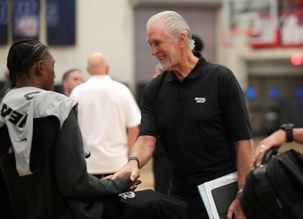 Miami Heat president Pat Riley shakes hands with forward Josh Richardson during training camp.