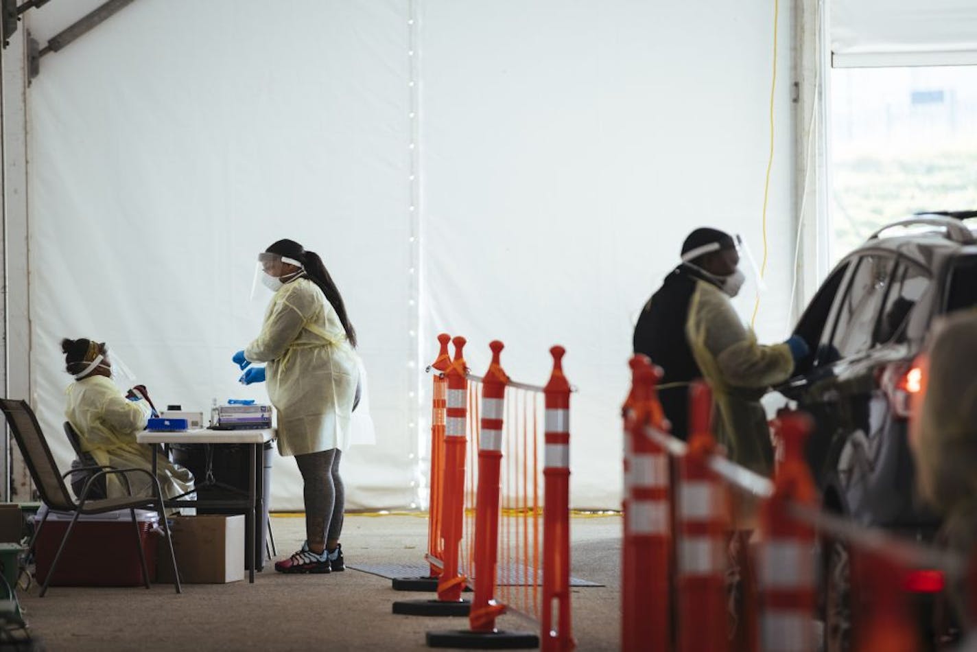 Workers administer drive-thru coronavirus tests at a testing site in Milwaukee, Nov. 5, 2020. Republican attorneys general in 18 states and the administration want the Affordable Care Act to be struck down, which would threaten coverage for more than 23 million people.