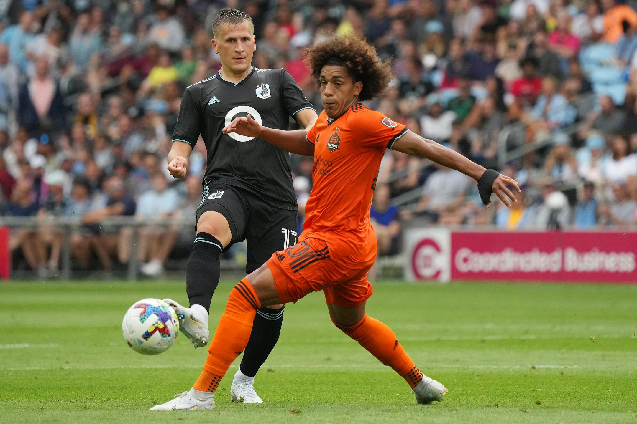 Minnesota United midfielder Robin Lod (17) sends the ball past Houston Dynamo midfielder Adalberto Carrasquilla (20) in the first half of an MLS game between Minnesota United and the Houston Dynamo.