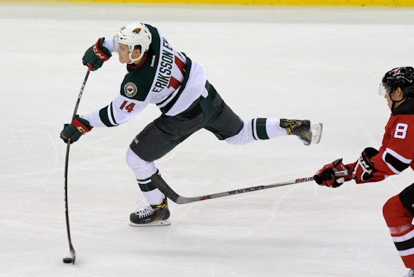 Minnesota Wild center Joel Ericsson El (14) shoots as New Jersey Devils right wing Beau Bennett looks on during the third period of an NHL hockey game