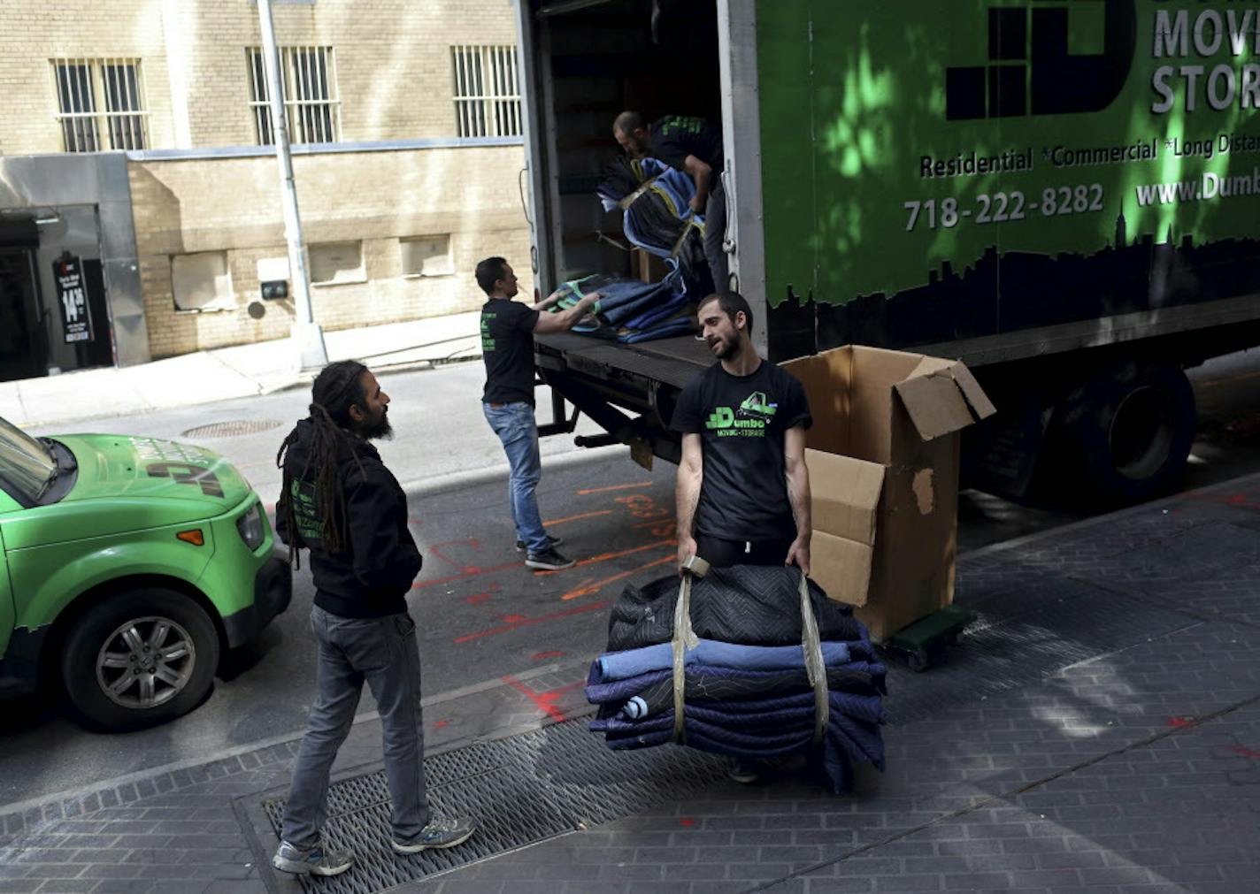 Lior Rachmany, left, owner of Dumbo Moving & Storage, and some employees, working in New York, May 16, 2016. Employers say a change in the salary cutoff for overtime pay will be a challenge to small businesses that pride themselves on a scrappy, entrepreneurial culture. Rachmany said he would probably hire more entry-level employees and minimize overtime pay for his salaried employees. (Yana Paskova/The New York Times)